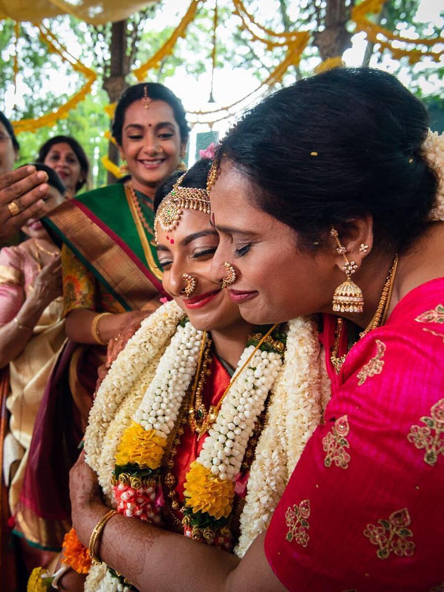 mother in law hugging her to be daughter in law in an Indian wedding